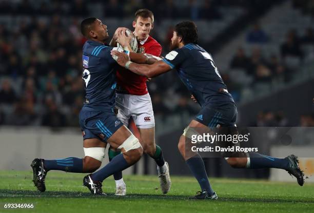 Liam Williams of the Lions is tackled by Jimmy Tupoli and Steven Luatua during the match between the Auckland Blues and the British & Irish Lions at...