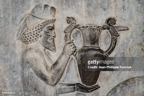 bas-relief from the apadana depicting an armenian bringing their famous wine to the king,  ancient city of persepolis, shiraz, fars province, iran - persian stock pictures, royalty-free photos & images