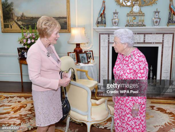 Queen Elizabeth II shakes hands with the Governor of western Australia Kerry Sanderson during at a private audience in Buckingham Palace on June 7,...