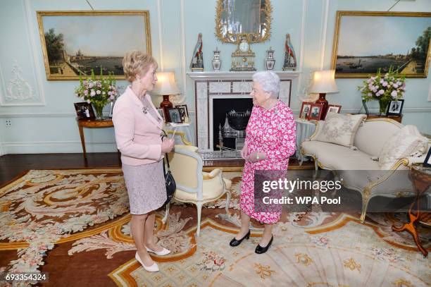 Queen Elizabeth II shakes hands with the Governor of western Australia Kerry Sanderson during at a private audience in Buckingham Palace on June 7,...