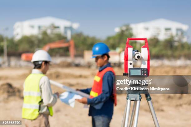 civil engineers at construction site and a land surveyor using an altometer - autocad stock pictures, royalty-free photos & images