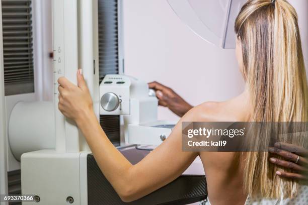 woman getting mammogram - mammogram diversity stock pictures, royalty-free photos & images