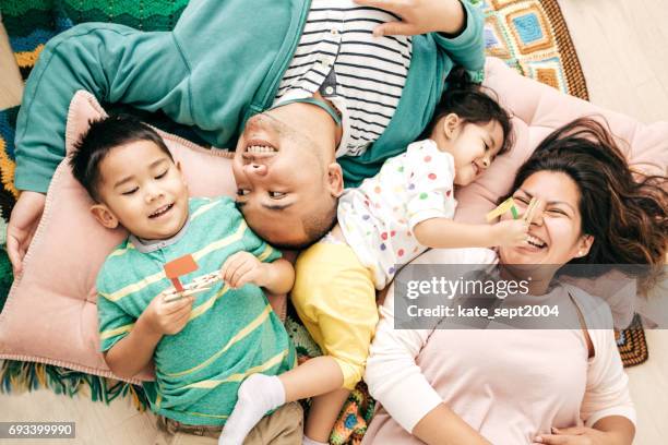 relaxed parenting - family at home stock pictures, royalty-free photos & images