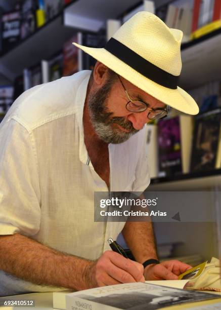 The writer Juan Madrid signs a book during the Book Fair 2017 at El Retiro Park on June 3, 2017 in Madrid, Spain.