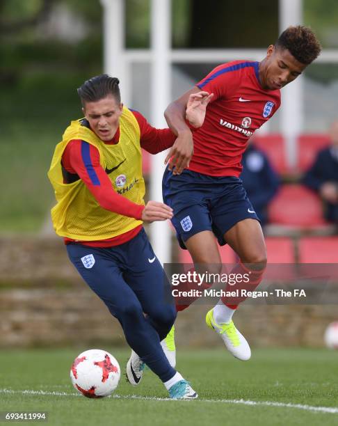 Jack Grealish of England U21 is challenged by Mason Holgate of England U21 during the England U21 training session at St Georges Park on June 7, 2017...