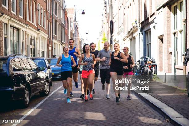 urban runners crew training in the city - practicing stock pictures, royalty-free photos & images