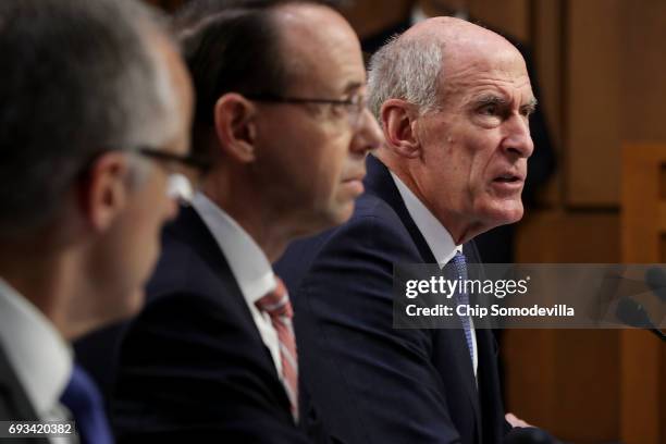 Acting FBI Director Andrew McCabe and Deputy Attorney General Rod Rosenstein listen as Director of National Intelligence Daniel Coats delivers...