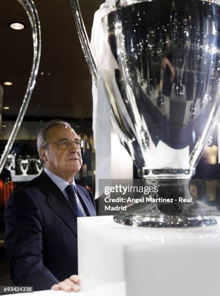 President Florentino Perez of Real Madrid places the 12th UEFA Champions League trophy in Real Madrid museum at Estadio Santiago Bernabeu on June 7,...