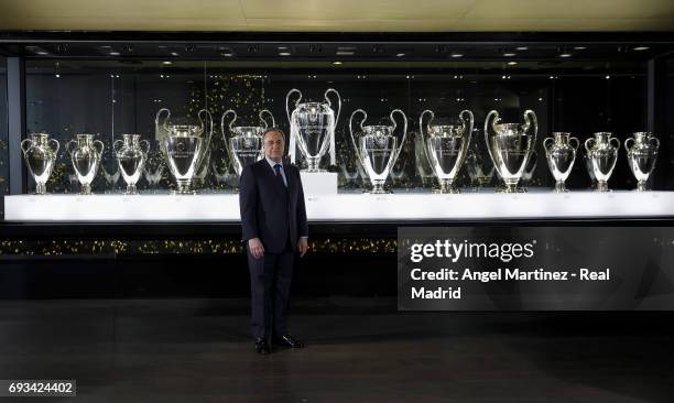 President Florentino Perez of Real Madrid places the 12th UEFA Champions League trophy in Real Madrid museum at Estadio Santiago Bernabeu on June 7,...