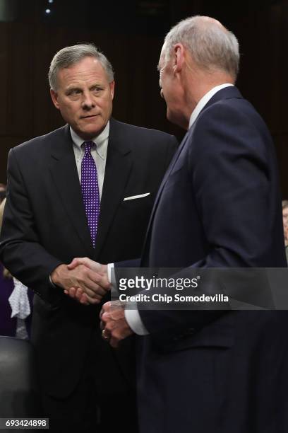 Senate Intelligence Committee Chairman Richard Burr greets Director of National Intelligence Daniel Coats before a hearing in the Hart Senate Office...