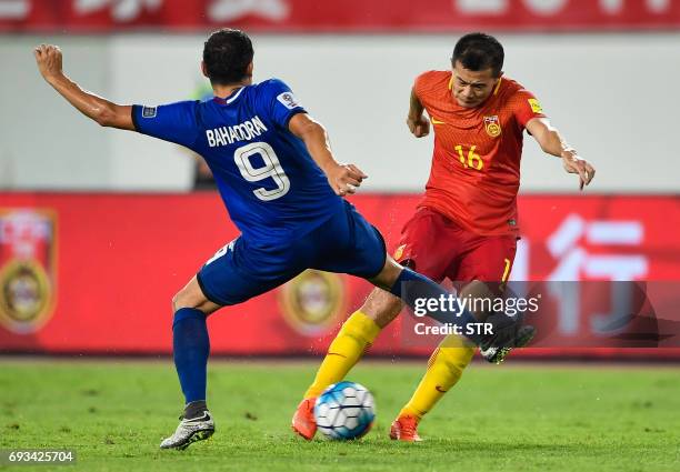 China's Huang Bowen kicks the ball as he is challenged by Misagh Bahadoran of the Philippines during their football friendly in Guangzhou, in China's...