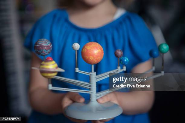 child holding plastic model of the planets in our solar system - solar system 個照片及圖片檔