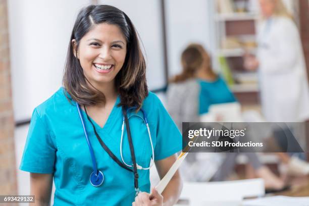 confident filipino nurse at work in emergency room - filipino ethnicity stock pictures, royalty-free photos & images