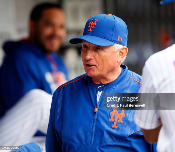 Manager Terry Collins of the New York Mets talks to some players in the dugout after he challenged a call at first base when it was obvious the...