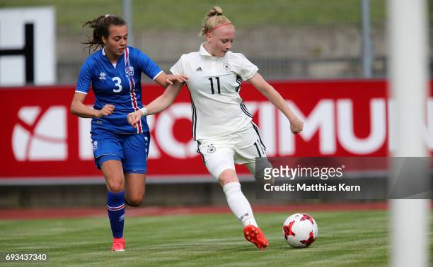 Anna Gerhardt of Germany battles for the ball with Droefn Einarsdottir of Iceland during the U19 women's elite round match between Germany and...