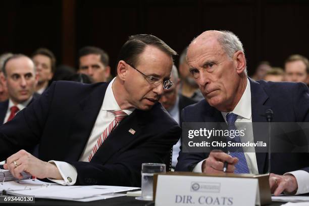 Deputy Attorney General Rod Rosenstein and Director of National Intelligence Daniel Coats talk while testifiying before the Senate Intelligence...