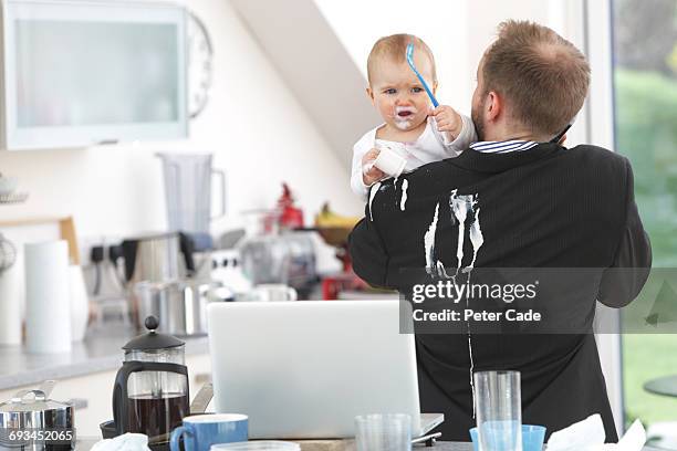 father with yogurt spilled on suit by baby - food stains stock pictures, royalty-free photos & images