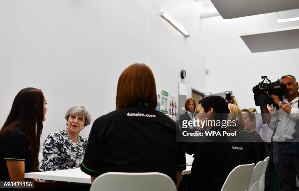 Britain's Prime Minister and leader of the Conservative Party Theresa May and husband Philip speak to staff at a Dunelm department store during a...