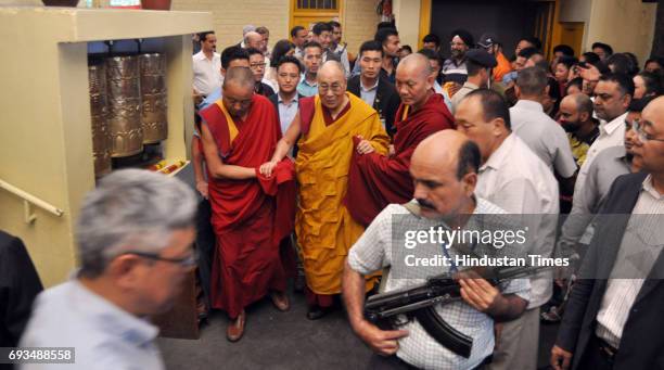Tibetan spiritual leader the Dalai Lama greets devotees as he arrives to give a religious talk at the Tsuglagkhang temple in McLeodGanj on June 7,...