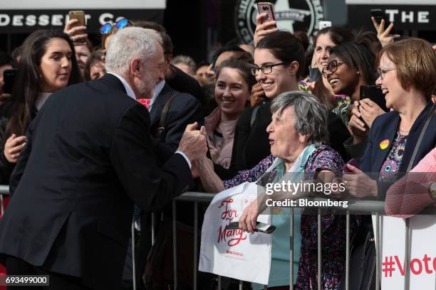 Jeremy Corbyn, leader of the U.K. Opposition Labour Party, left, shakes hands with an attendee during a general-election campaign rally in Watford,...