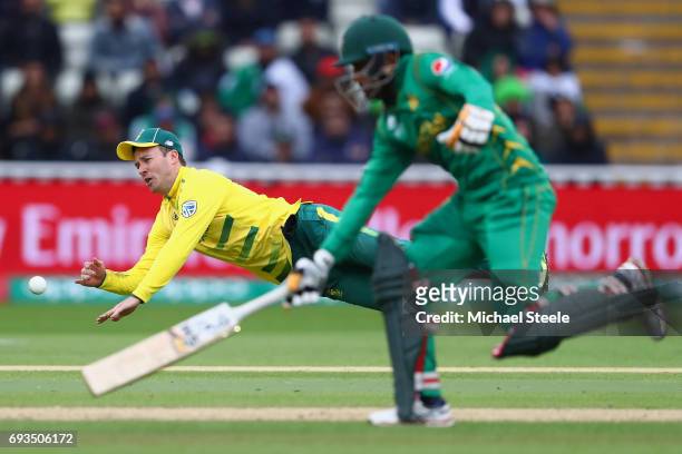 De Villiers of South Africa throws at the stumps as Babar Azam of Pakistan makes his ground during the ICC Champions Trophy match between Pakistan...