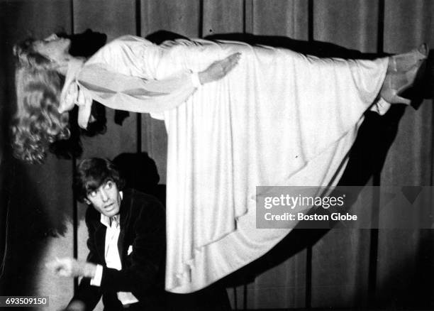 Magician David Copperfield performs as his assistant is elevated from the floor at the Wilbur Theatre in Boston on Oct. 2, 1984.