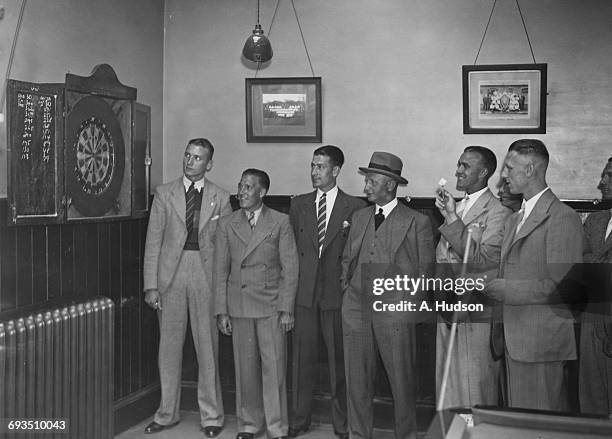 Tottenham Hotspur manager Peter McWilliam , watching some of his players play darts in the recreation room at Spurs' White Hart Lane ground, London,...