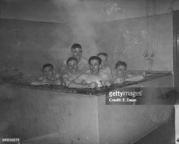 Tottenham Hotspur players in the bath after a practice game at Spurs' White Hart Lane ground, London, 11th February 1936.