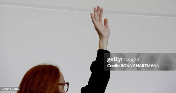 Artist Marie Cool performs with scotch tape during the Documenta 14 art exhibition in Kassel on June 7, 2017. Documenta 14 takes place from April 8...