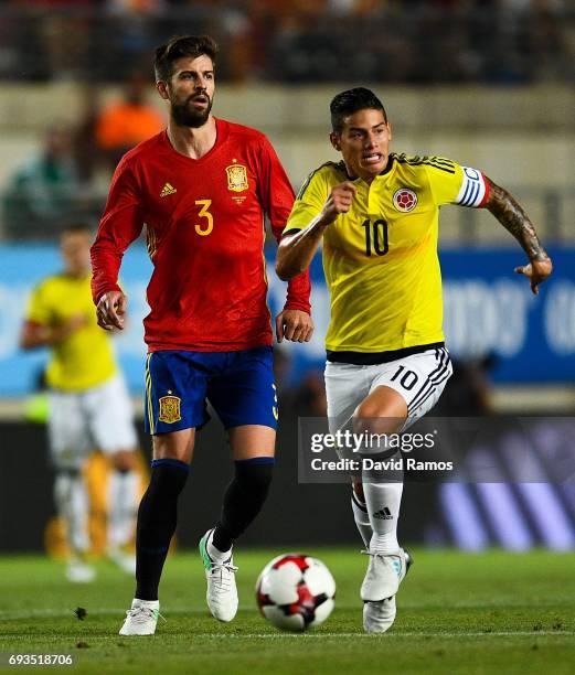 Gerard Pique of Spain and James Rodriguez of Colombia compete for the ball during a friendly match between Spain and Colombia at La Nueva Condomina...
