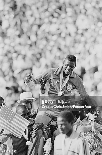 American athlete and sprinter Carl Lewis is carried on the shoulders of his teammates after the United States team won the final of the Men's 4 x 100...