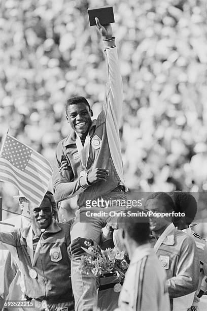 American athlete and sprinter Carl Lewis is carried on the shoulders of his teammates Calvin Smith, Ron Brown and Sam Graddy after the United States...