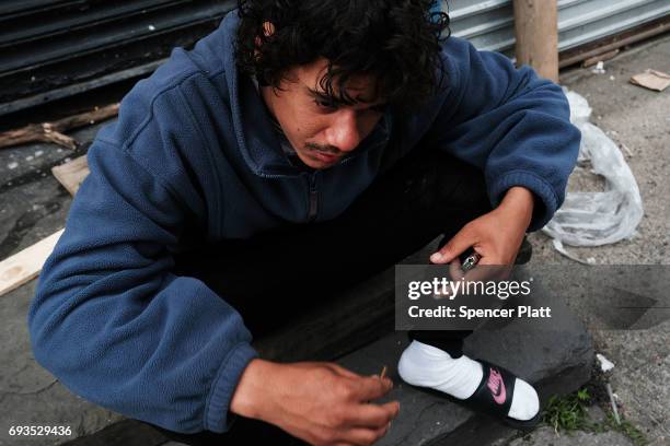 Brian smokes a synthetic drug called K2 on the street in the South Bronx on June 7, 2017 in New York City. Like Staten Island, parts of the Bronx are...