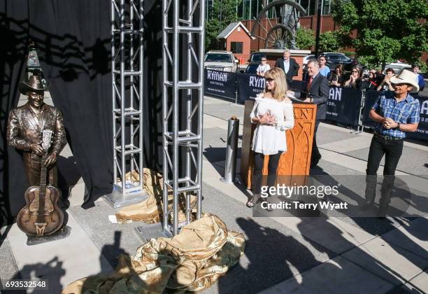 Singer-songwriter Brad Paisley and Mona Dickens attend the unveiling of statues of Little Jimmy Dickens and Bill Monroe at Ryman Auditorium on June...