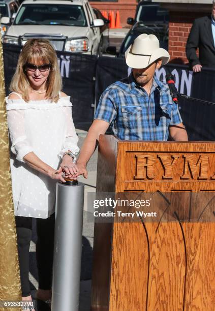 Singer-songwriter Brad Paisley and Mona Dickens attend the unveiling of statues of Little Jimmy Dickens and Bill Monroe at Ryman Auditorium on June...