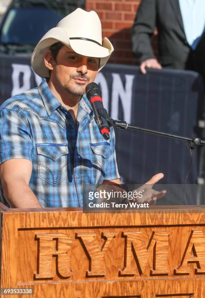 Singer-songwriter Brad Paisley speaks during the unveiling of statues of Little Jimmy Dickens and Bill Monroe at Ryman Auditorium on June 7, 2017 in...