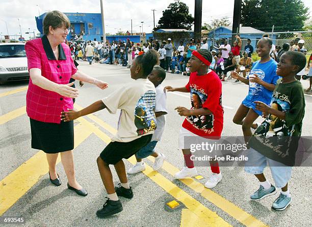 Former US Attorney General Janet Reno, who is running for governor of Florida against Jeb Bush, greets children at the Liberty City Parade in honor...