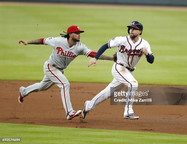 Shortstop Freddy Galvis of the Philadelphia Phillies tags centerfielder Ender Inciarte of the Atlanta Braves during a rundown in the first inning...