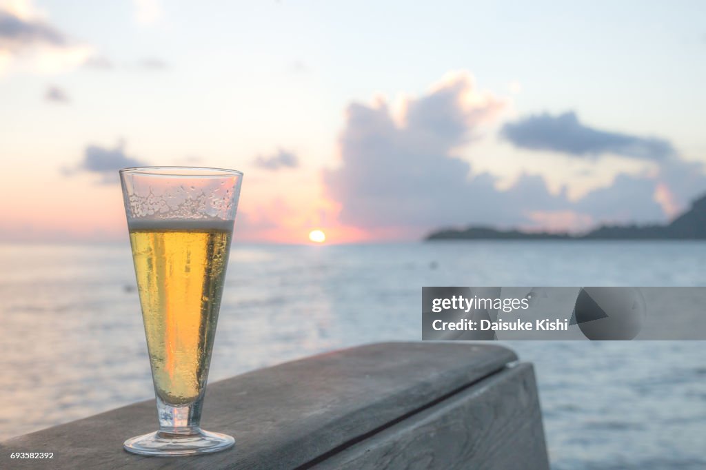 A glass of beer on a sunset in Bora Bora, Tahiti, French