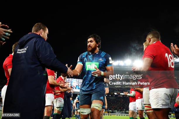 Steven Luatua of the Blues is congratulated by the Lions team after winning the match between the Auckland Blues and the British & Irish Lions at...