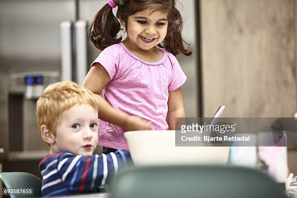 children baking a cake - bjarte rettedal stock pictures, royalty-free photos & images