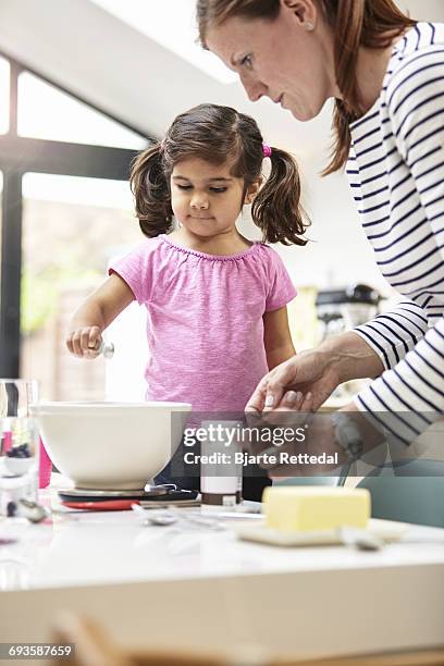 girl baking a cake - bjarte rettedal stock pictures, royalty-free photos & images
