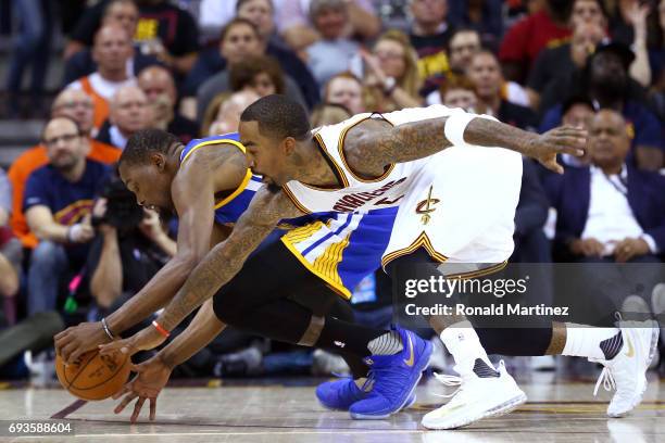 Kevin Durant of the Golden State Warriors competes for the ball with JR Smith of the Cleveland Cavaliers in the first half in Game 3 of the 2017 NBA...