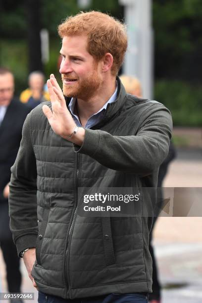 Prince Harry waves to a small group of onlookers as he arrives for a venue tour of the Sydney International Aquatic Centre on June 8, 2017 in Sydney,...
