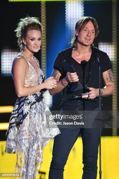 Carrie Underwood and Keith Urban accept an award onstage at the 2017 CMT Music Awards at the Music City Center on June 7, 2017 in Nashville,...