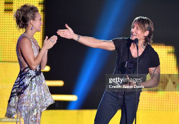 Carrie Underwood and Keith Urban accept an award onstage at the 2017 CMT Music Awards at the Music City Center on June 7, 2017 in Nashville,...