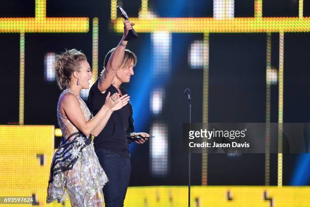 Carrie Underwood and Keith Urban accept an award onstage at the 2017 CMT Music Awards at the Music City Center on June 7, 2017 in Nashville,...
