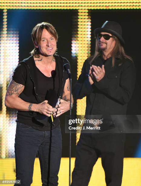 Keith Urban accepts an award from Kid Rock onstage during the 2017 CMT Music Awards at the Music City Center on June 7, 2017 in Nashville, Tennessee.