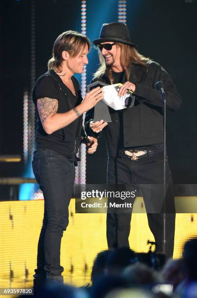 Keith Urban accepts an award from Kid Rock onstage during the 2017 CMT Music Awards at the Music City Center on June 7, 2017 in Nashville, Tennessee.