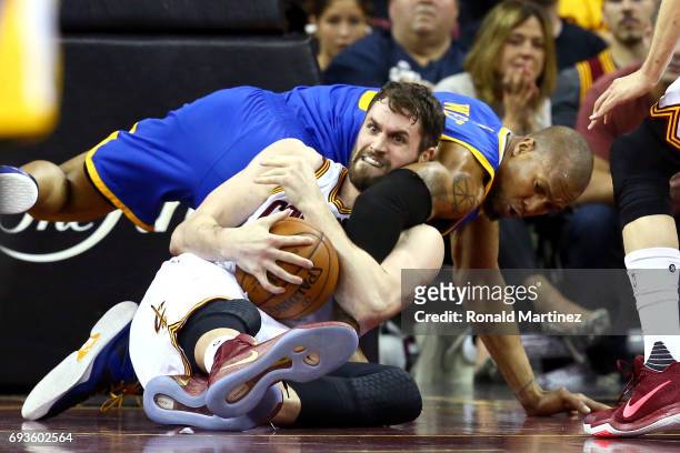 Kevin Love of the Cleveland Cavaliers competes for the ball with David West of the Golden State Warriors in the second half in Game 3 of the 2017 NBA...